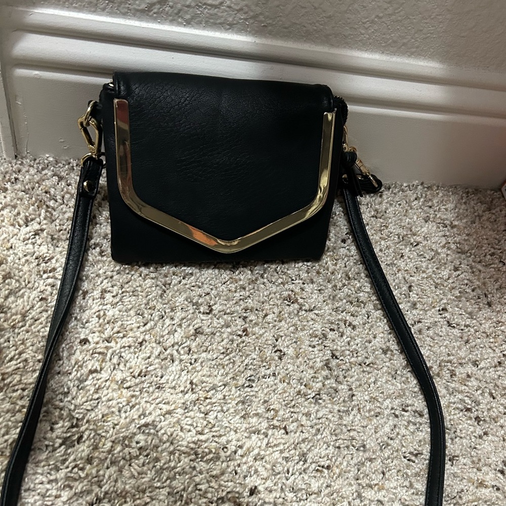 Black leather crossover bag with gold hardware